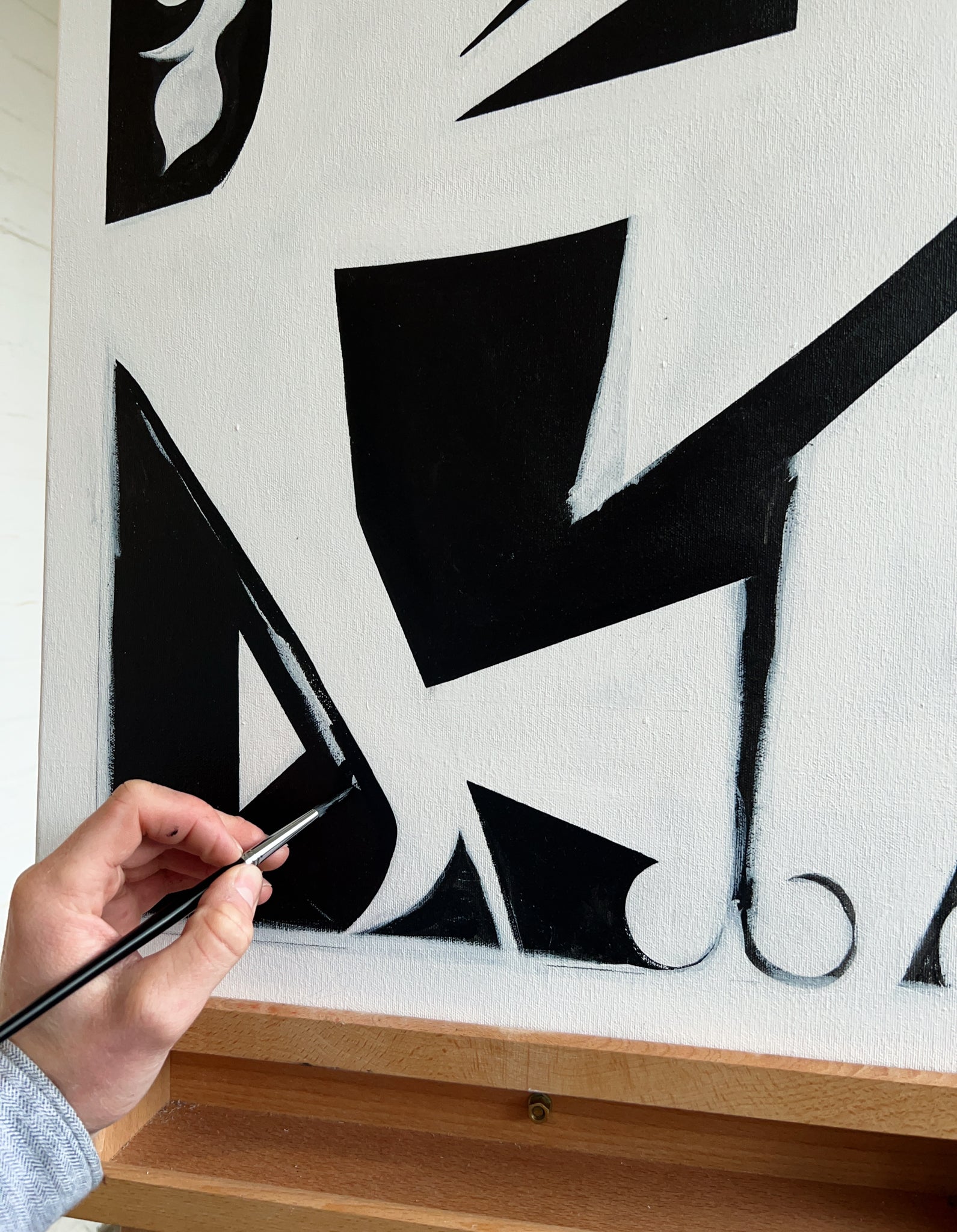 Black and white abstract artwork in progress on canvas